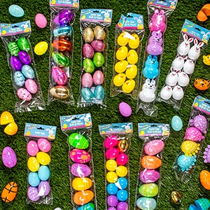 Plastic Easter eggs in their packaging on grass.