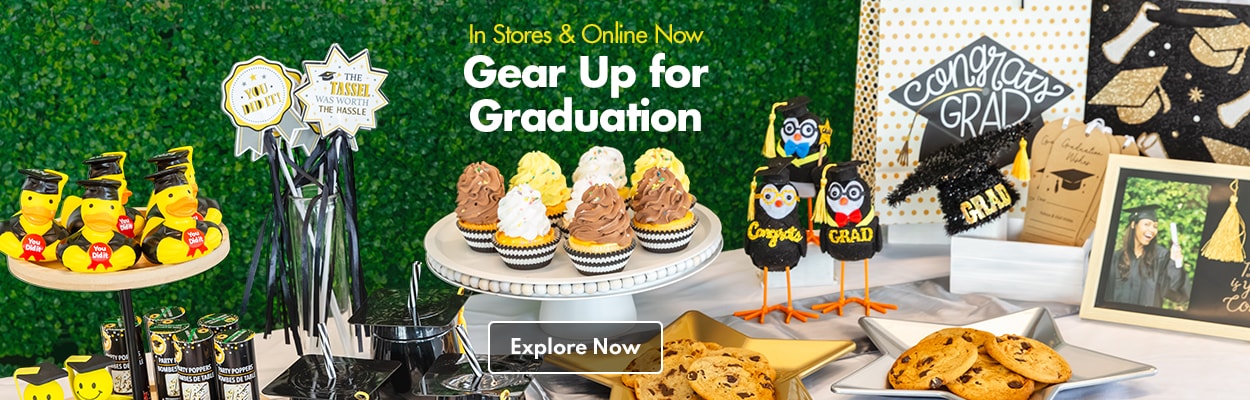 Assortment of graduation party supplies, including decorations, food, serveware, and more on a table