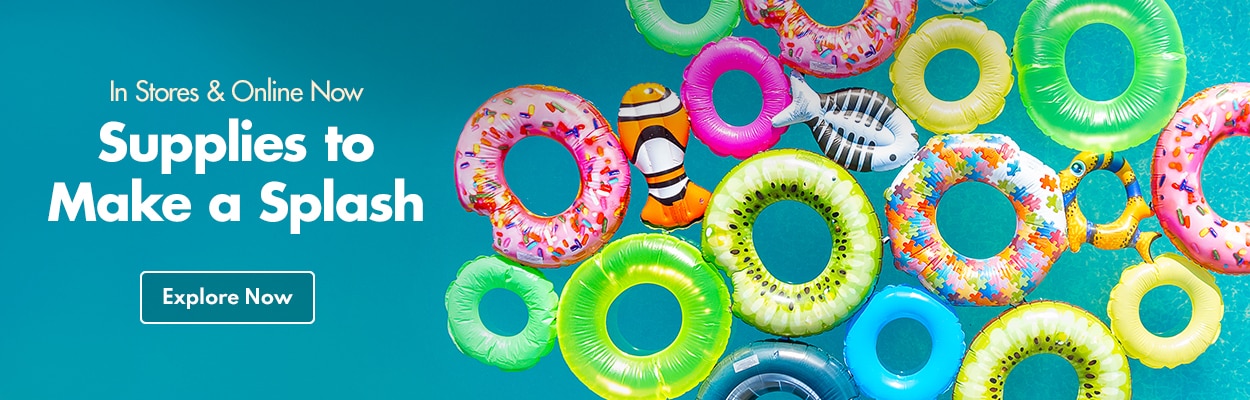 Variety of inflatable floats in a pool with bright colors and prints inspired by fruit, fish, & donuts