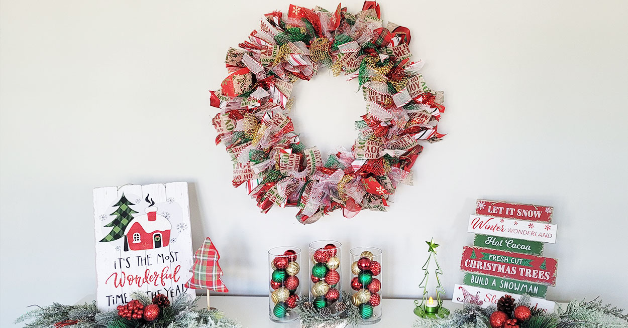 A round wreath form decorated with a variety of Christmasthemed ribbon