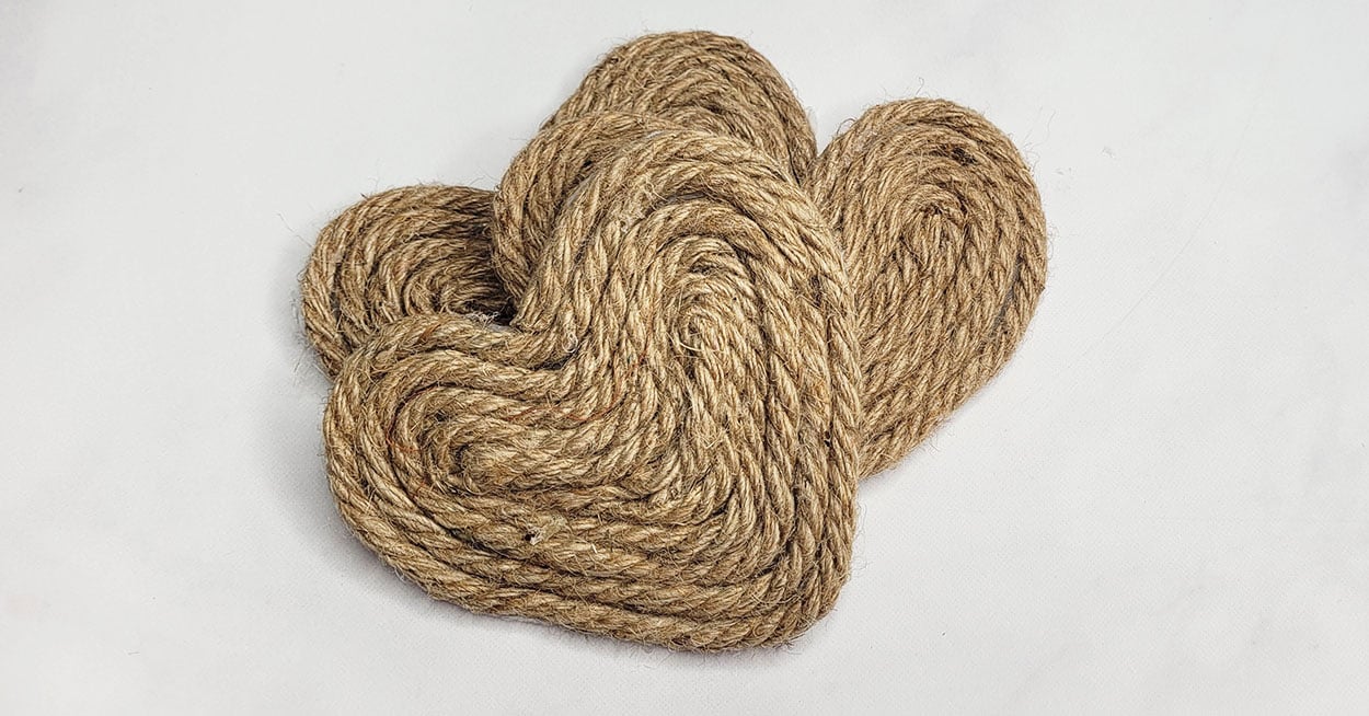 Three heartshaped coasters made out of nautical rope.