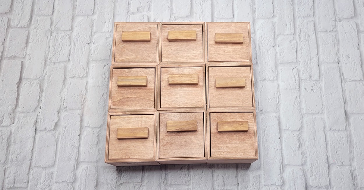 A light brown wooden organizer with drawers.