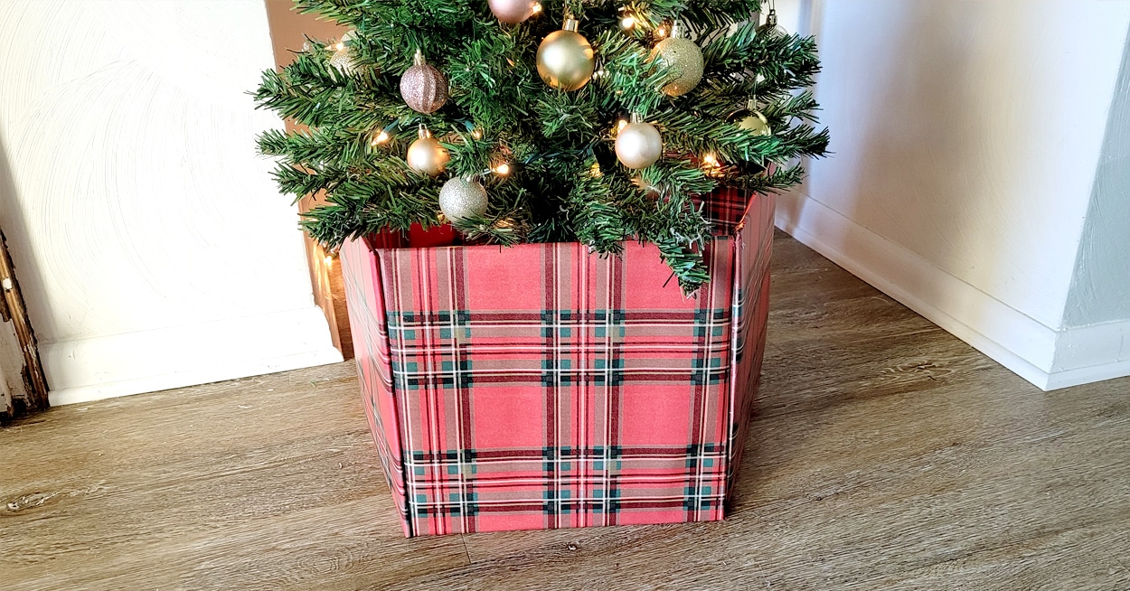 A Christmas tree with a red plaid tree collar.