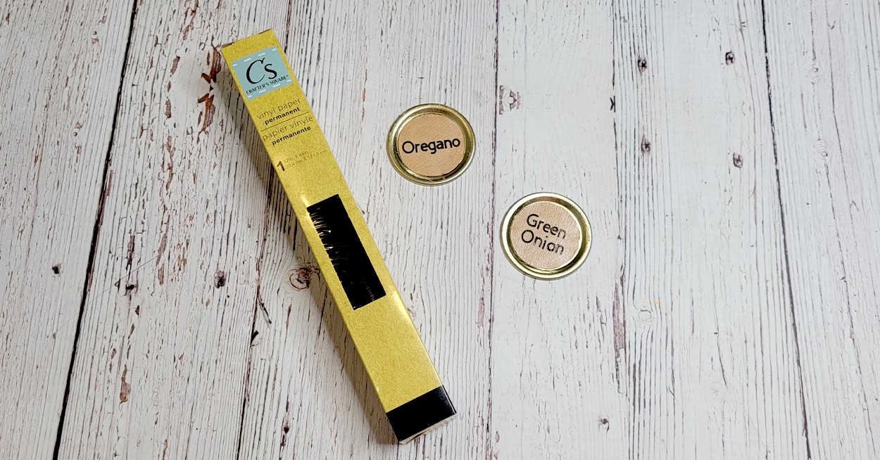 A package of vinyl paper and 2 lids with cardstock and lettering on them.