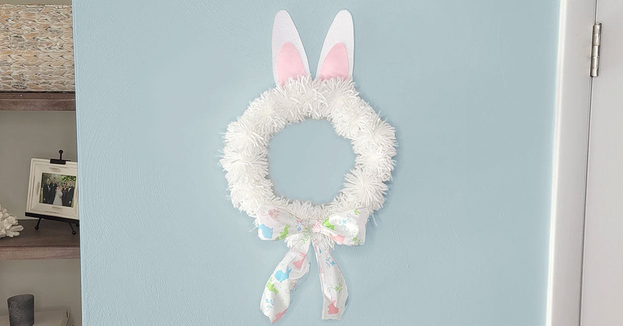 Dollar Tree DIY Easter wreath made with yarn pom poms, paper bunny ears ...